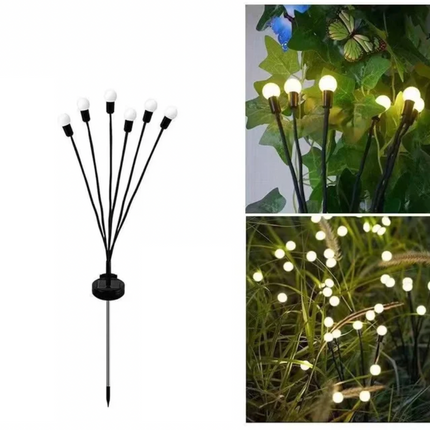 Eldflugor på solceller för trädgården, svänger i vinden.