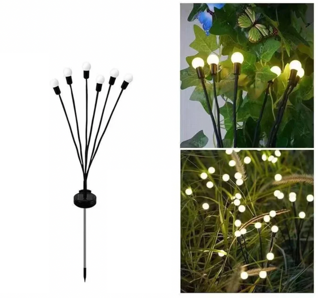 Eldflugor på solceller för trädgården, svänger i vinden.